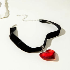 Gothic choker featuring a large red heart pendant on soft black velvet ribbon