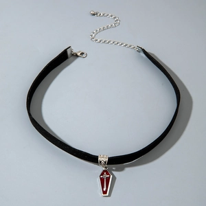 Detail of gothic black velvet choker with silver coffin cross pendant and red finish