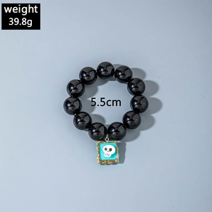 Black beaded bracelet with blue skull charm detail, weight 39.8g and width 5.5cm