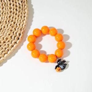 Detailed view of Halloween beaded bracelet featuring orange beads and ghost pumpkin charm