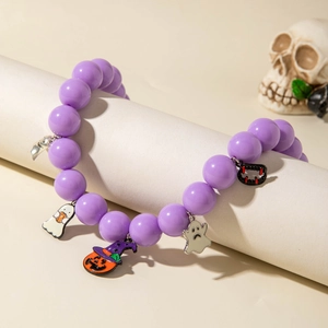 Detail of Halloween beaded bracelet with pumpkin, ghost and vampire fang charms