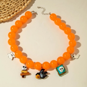 Detail of Halloween beaded necklace with pumpkin and ghost charms on white table
