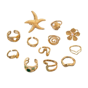 11-piece gold alloy beach ring set featuring starfish, pearls and green gemstone