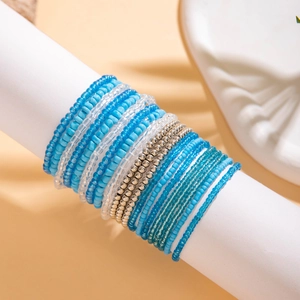 Detail of blue and white layered bohemian beaded bracelet set on a display stand