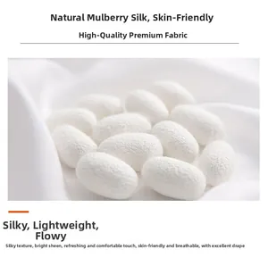 Detail of natural mulberry silk fabric with white cocoons showing smooth texture