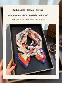 Detail of silk-like scarf with equestrian horse print on tray with accessories