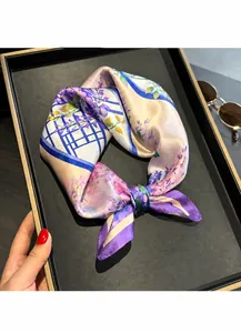 Detailed macro view of the lavender floral silk scarf texture on a display tray