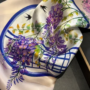 Close-up of silky lavender scarf with wisteria flower and swallow bird print