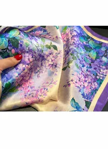 Detail shot of lightweight floral scarf showing silky texture and fine edge stitching