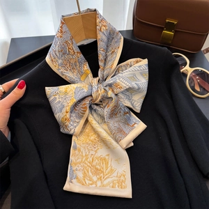 Elegante sciarpa in seta a fiori su un maglione nero con un look vintage e chic