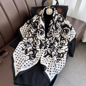 Close-up of black and white polka dot scarf with camellia and rose floral patterns