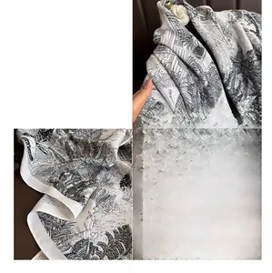 Detailed macro view of the elegant floral and animal print silk scarf with fine rolled edges