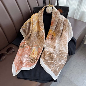 Floral leaf print 90cm square scarf with leopard pattern over elegant brown leather sofa