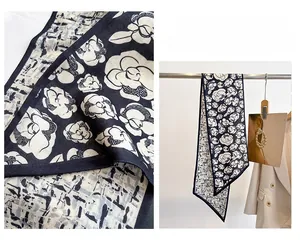 Detail of floral geometric narrow silk scarf showing fabric texture and elegant drape