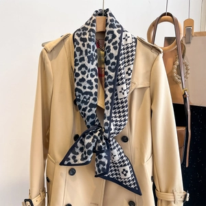 Classic beige double-breasted trench coat with a leopard and floral pattern scarf