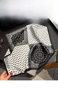 Close-up of silk square scarf featuring classic polka dots and paisley patterns