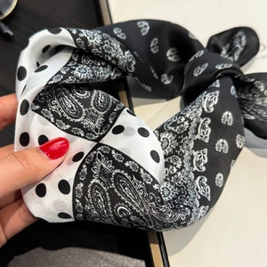 Detailed view of polka dot and paisley pattern silk scarf for hair and neck styling