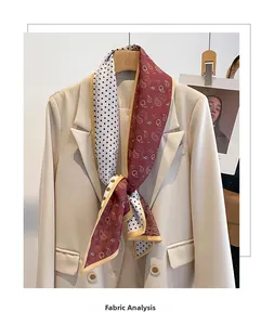Detail of double-sided silk scarf with polka dots and paisley patterns on a blazer