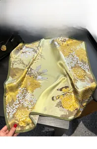 Detail of silk scarf showing vintage floral pattern with golden yellow and olive green edges