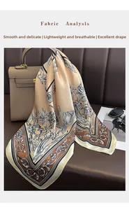 Detail of floral silk-like scarf with black borders draped on a handbag