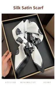 Detail of silk-like satin square scarf with elegant black and white rose print pattern
