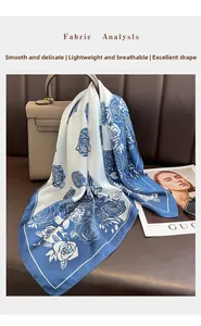 Detail showing elegant blue rose floral patterns on high-quality silk-like fabric scarf