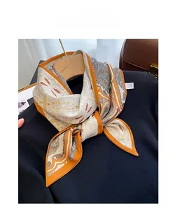 Detailed texture of retro paisley print scarf with silk-like finish and orange edges