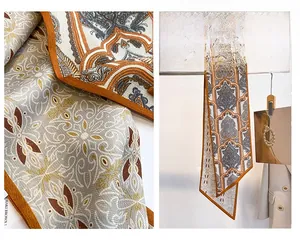 Detail of paisley geometric pattern on khaki brown professional neck scarf for women
