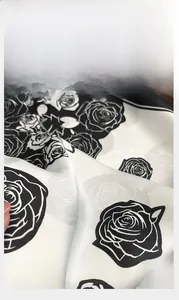 Close-up of black and white rose print silk scarf showing precise edge stitching details