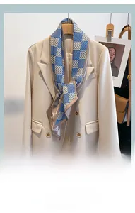 Détail d'un élégant foulard en soie bleu et marron à motifs géométriques sur un blazer