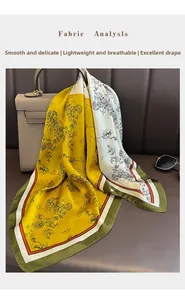Close-up of printed silk-like scarf with floral patterns tied on a handbag handle