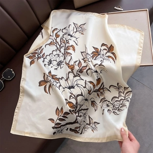 Detail view of large ivory square scarf with vintage floral patterns and silk sheen