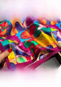 Close-up of fine purple rolled hem and colorful oil painting pattern on silk scarf