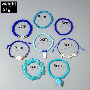 Detail of 8pcs blue bohemian beach bracelets set with shell and starfish charms
