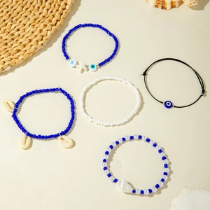 Detail of 5-piece bohemian beaded bracelet set with starfish and evil eye charms