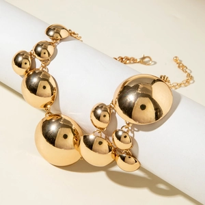 Exaggerated golden chunky chain necklace with smooth geometric dome pendants in mirror finish