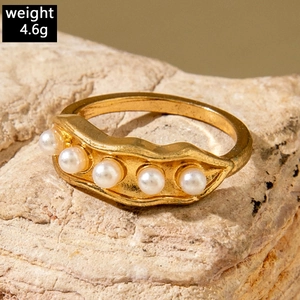 Macro view of gold pea pod ring with five white pearls weighing 4.6g on stone