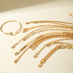 Ensemble détaillé de bracelets dorés avec motifs de chaînes serpent et gourmettes