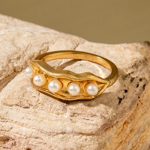 Elegant gold pearl ring with five white pearls on a wave-shaped textured band