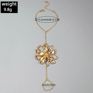 Detailed view of a gold flower hand harness chain with ring and hollow petal design