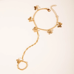 Detailed view of a gold butterfly hand chain ring with intricate stamped butterfly charms