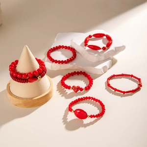 Bohemian 6-piece red beaded bracelet set with heart charms and gold metallic accents