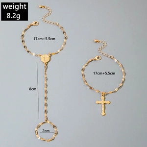 Detail view of gold slave bracelet and cross charm set with size and weight 8.2g labels