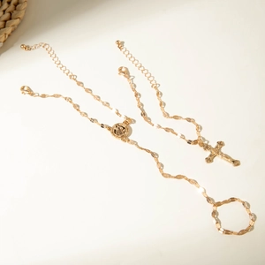 Detail of gold religious bracelet ring with cross pendant and round icon charm