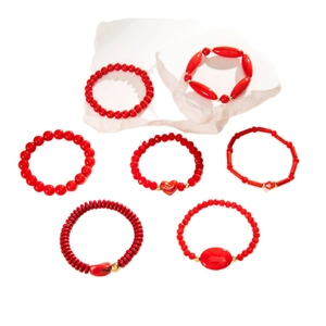 Set of 7 vintage red beaded bracelets with gold accents and heart charms for layering