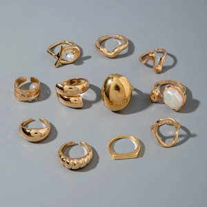 Detailed set of eleven gold-tone alloy rings with geometric designs and pearl accents