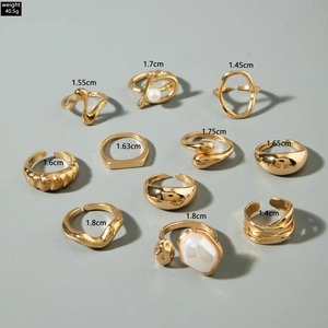 Macro shot of 10-piece gold alloy ring set showing size diameters and vintage textures
