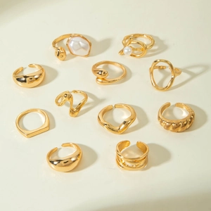 Detailed overhead view of 11-piece vintage gold alloy ring set with geometric hollow designs