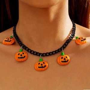 Close-up of black metal chain choker featuring five orange Halloween pumpkin charms
