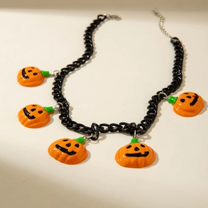 Close-up of Halloween choker with black chunky chain and five orange pumpkin pendants
